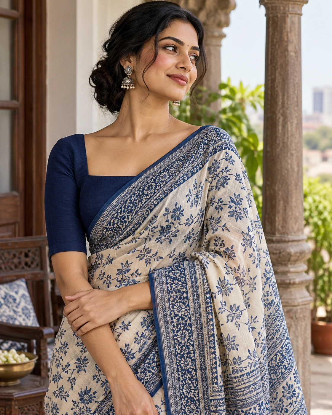 A plain elbow-sleeved blouse gives a patterned saree a calm frame.