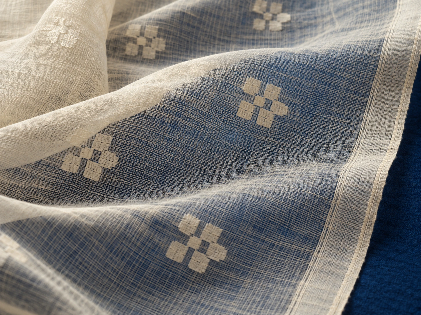 Small opaque woven floral motifs appear against a translucent cotton ground.