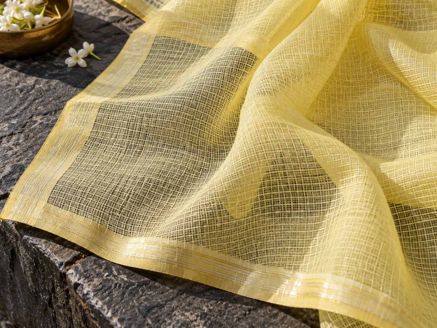 An airy square-checked ground is visible in a lightly folded pale textile.